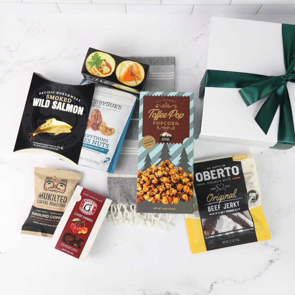 Assorted snack packages including smoked salmon, coffee, popcorn, and beef jerky on a white surface.